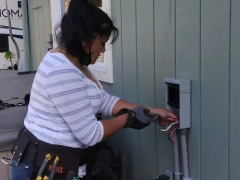 Licensed electrician wiring an exterior subpanel in Branson